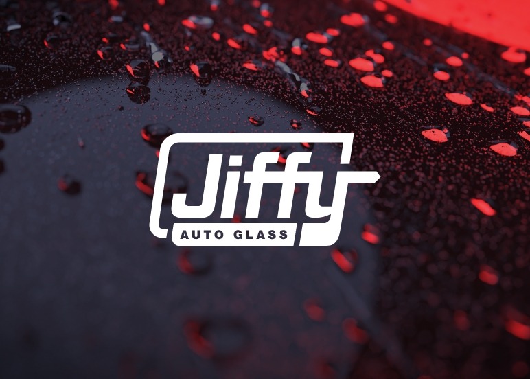 Photo of Jiffy Auto Glass logo on top of a car windshield | Jiffy Auto Glass USA | Colorado's Best Auto Glass Repair